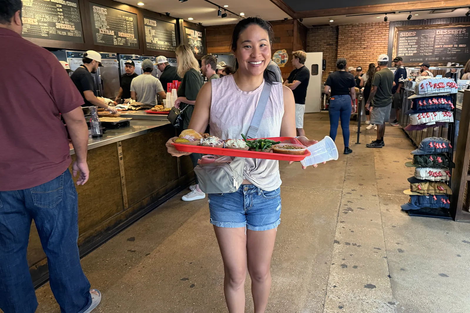 Samantha carrying our barbecue tray to the table at Terry Black’s