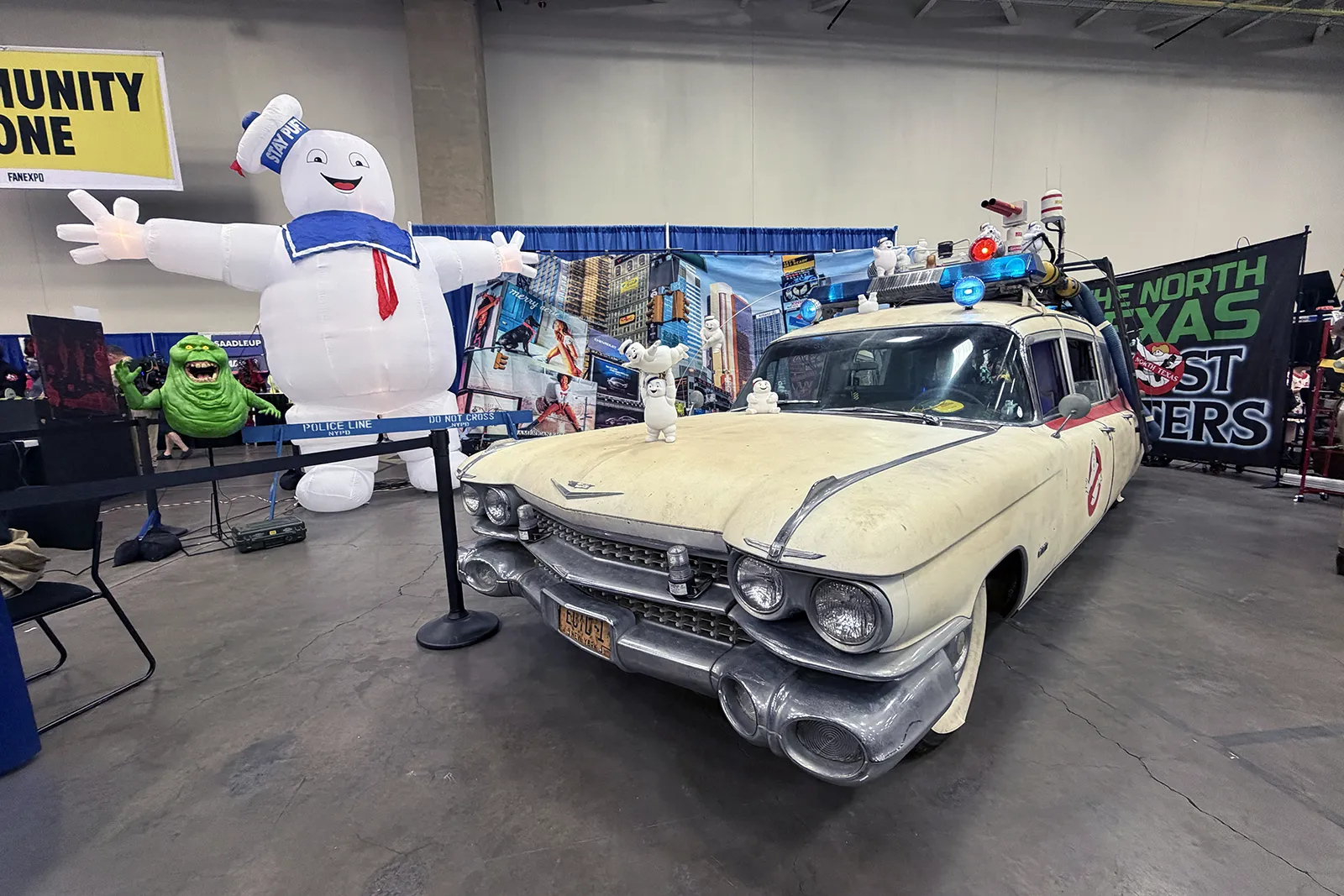 Ghostbusters Ecto 1 car and Stay Puft display at FAN EXPO Dallas