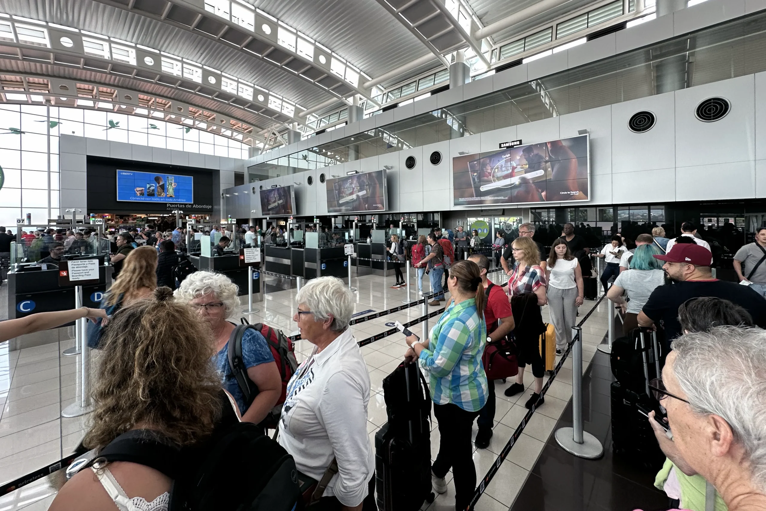 Long immigration line with travelers waiting