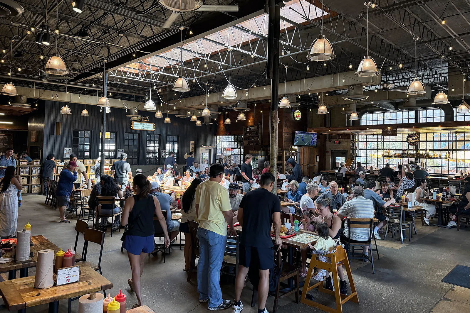 Busy main dining room inside Terry Black’s Barbecue in Dallas