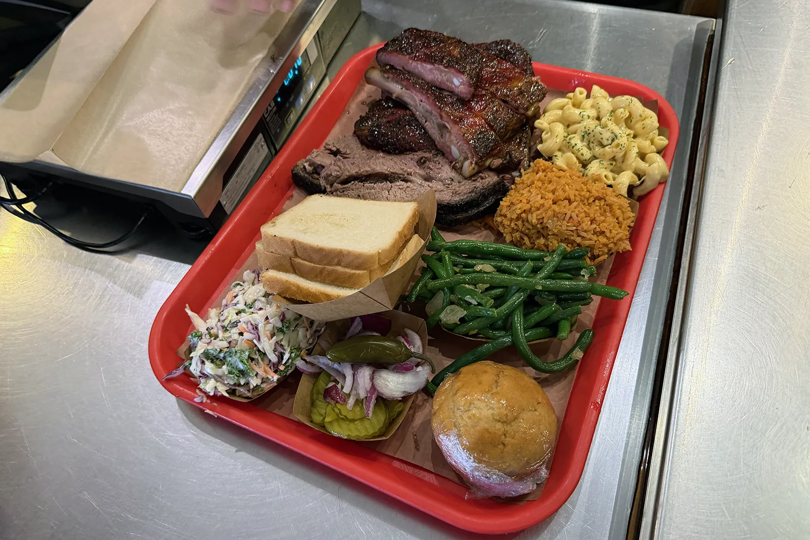Large tray with brisket, ribs and sides at Terry Black’s Barbecue