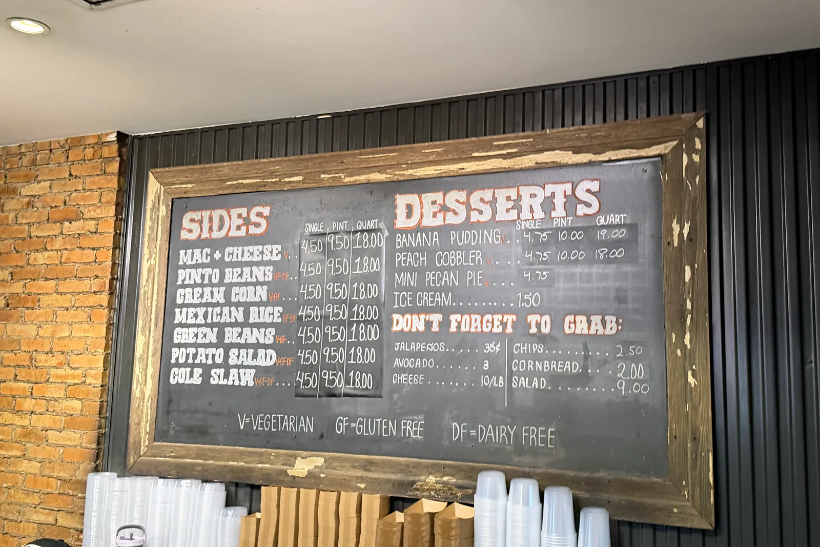 Terry Black’s chalkboard menu with side and dessert prices