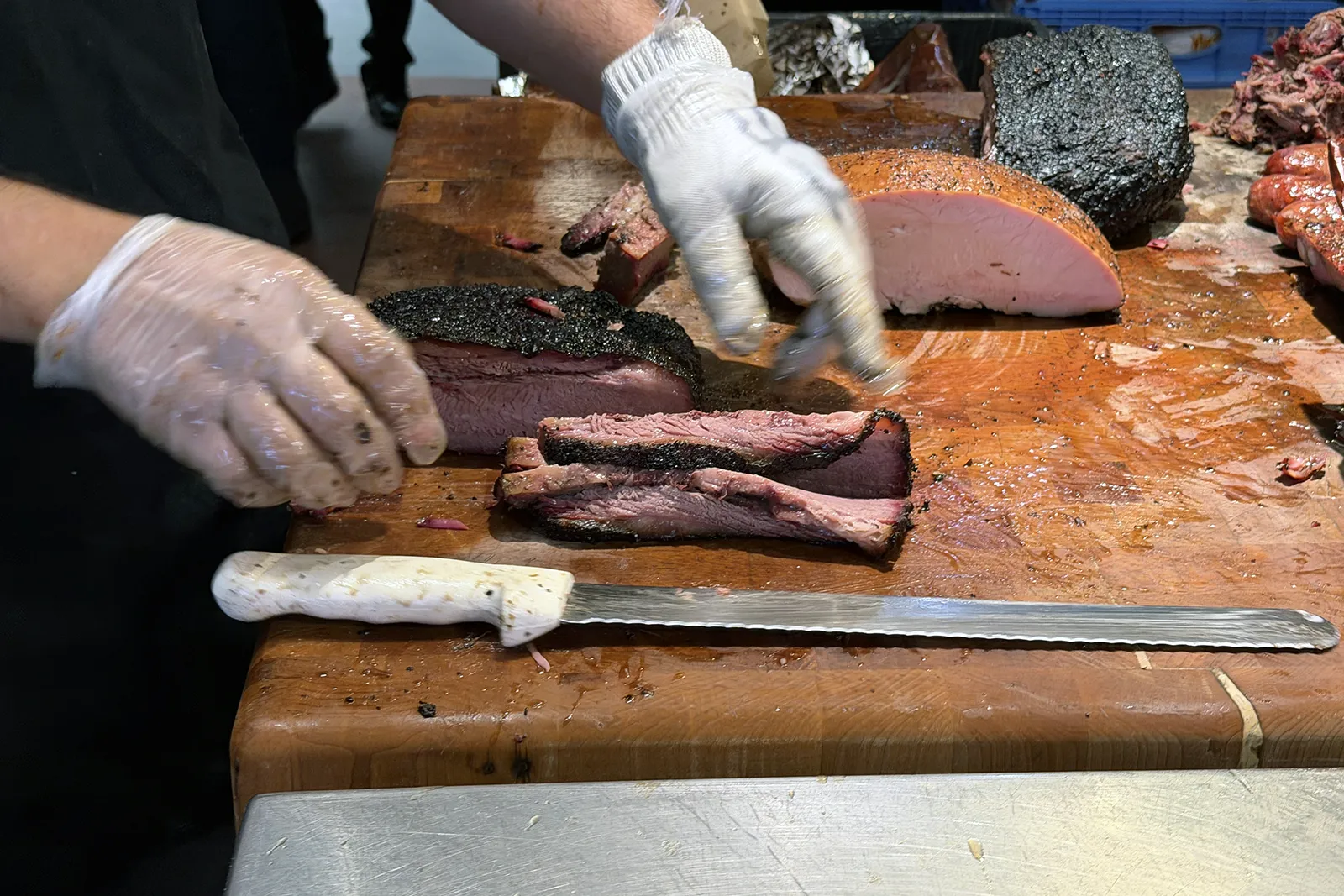 Meat cutter slicing brisket for an order at Terry Black’s