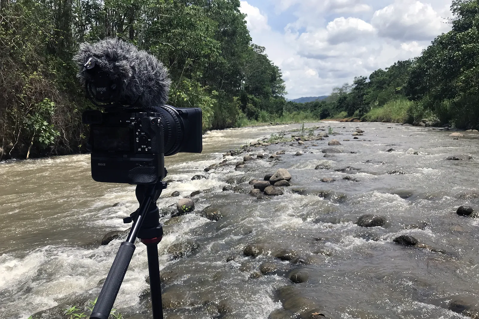 Working in the field creating content during a white water rafting tour